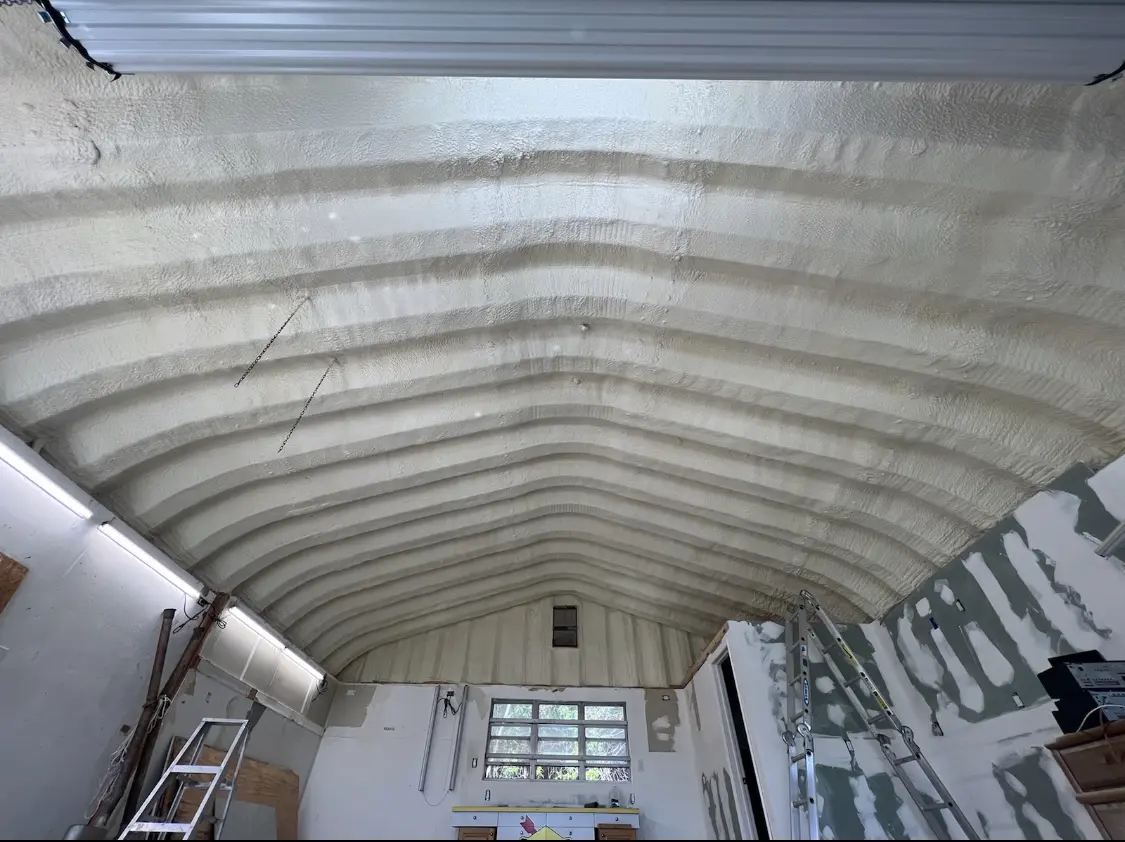 Spray polyurethane foam applied to the underside of a metal roof deck in Carlsbad
